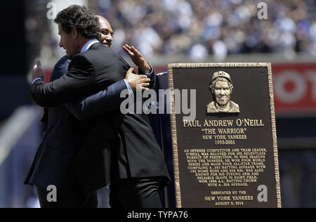 Les joueurs des Yankees de New York à la retraite Mariano Rivera et Paul O'Neill hug sur le terrain après une cérémonie introduit O'Neill en Monument Park avec une nouvelle plaque avant le match contre les Indians de Cleveland au Yankee Stadium de New York le 9 août 2014. Monument Park est un musée en plein air situé au new Yankee Stadium contenant une collection de monuments, plaques, et a pris sa retraite en l'honneur des numéros de membres éminents de la Nouvelle York yankee. UPI/John Angelillo Banque D'Images