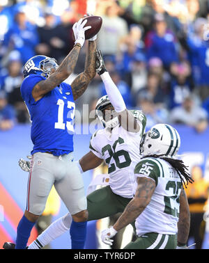 Les Giants de New York le receveur Odell Beckham (13) supprime un col comme New York Jets Darrin évoluait Murs (26) et New York Jets coffre fort Calvin Pryor (25) défendre au 2ème trimestre à MetLife Stadium à East Rutherford, New Jersey le 6 décembre 2015. Photo par Kane riche/UPI Banque D'Images