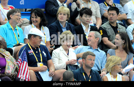 Le président des États-Unis George W. Bush a un chat bried fondateur de Microsoft Bill Gates (L) tout en regardant la piscine événements au Centre national de natation aux Jeux olympiques de cet été à Pékin le 11 août 2008. La fille du président Barbara est à droite et la Première dame Laura Bush est au centre. (Photo d'UPI/Pat Benic) Banque D'Images