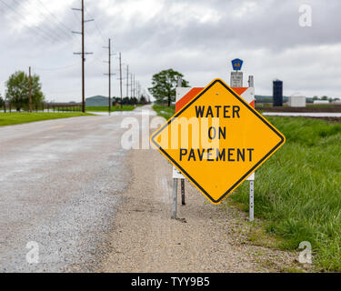 L'eau sur des panneaux d'avertissement placé sur la chaussée en raison de l'inondation de la route de fortes pluies et des tempêtes dans le Midwest Banque D'Images