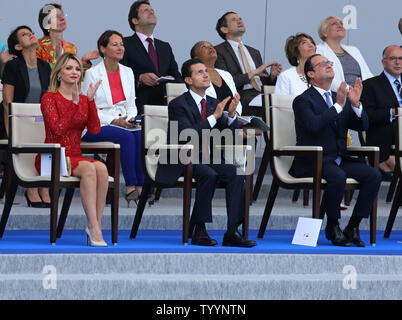 Le Président mexicain Enrique Pena Nieto (C), son épouse Angelica Rivera (L), et le président français François Hollande, regarder l'annual Bastille Day Parade militaire à la place de la Concorde à Paris le 14 juillet 2015. Photo de David Silpa/UPI Banque D'Images