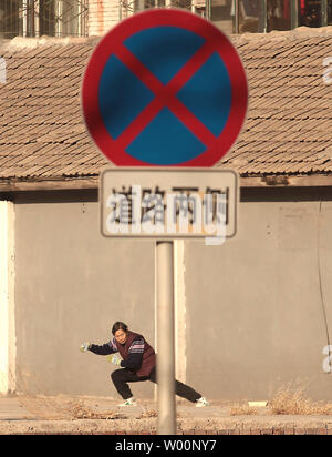 Une vieille femme chinoise arts martiaux pratiques sous le soleil d'après-midi à Beijing le 26 décembre 2009. La Chine peut être aller de l'avant en tant que puissance mondiale, mais il commence aussi à faire face à l'effet à long terme de sa politique de l'enfant - trop de personnes âgées et pas assez de jeunes. La Chine a le plus grand nombre de personnes âgées dans le monde, avec des estimations officielles de 143 millions de dollars, soit un cinquième du total mondial. UPI/Stephen Shaver Banque D'Images