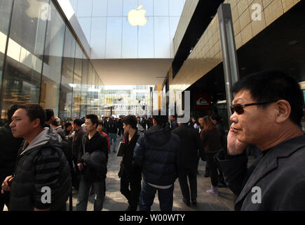 Des groupes de Chinois s'attarder à l'extérieur du magasin phare d'Apple dans l'espoir de la corruption pour les acheteurs leur carte d'identité afin d'acheter des iPhones à Beijing le 3 avril 2011. Les hommes, qui paient comptant et habituellement acheter jusqu'à 60 iPhones par jour, alors à la vente des téléphones portables à des prix plus élevés en dehors de Beijing. Limites Apple achète à deux iphone par personne, et pour décourager les visites répétées il tient un registre des cartes de crédit utilisées, mais les achats en espèces ne sont pas suivis. Apple dit la limite 'aide à s'assurer qu'il y a suffisamment d'iphone pour les personnes qui font des achats pour eux-mêmes ou d'acheter un cadeau.' UPI/S Banque D'Images