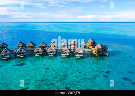 Paradis de vacances voyage vidéo drone aérien avec bungalows sur pilotis dans la lagune de corail mer. Vidéo aérienne de Bora Bora, Polynésie Française, Tahiti, l'océan Pacifique Sud. Banque D'Images