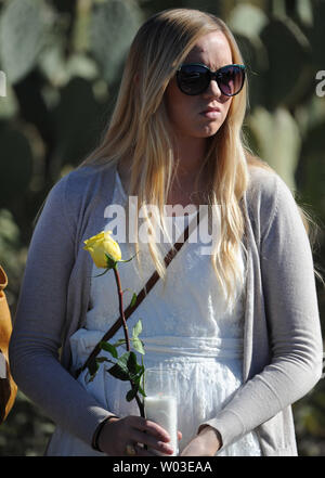 Une jeune femme attend sur le bord de la route pour neuf ans, Christina Taylor Green, qui a été tué samedi dernier lors du tournage de la députée Gabrielle Giffords, d'adopter pour ses funérailles à Tucson, Arizona, le 13 janvier 2011. UPI/Art Foxall Banque D'Images