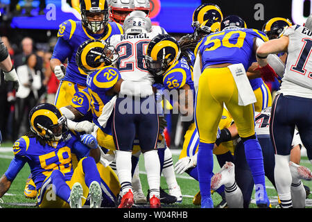 New England Patriots running back Michel Sony (26) est arrêté par Los Angeles Rams coffre Lamarcus Joyner (20) et les béliers de secondeur Mark Barron (26) sur un report au premier trimestre de Super Bowl LIII de Mercedes-Benz Stadium le 3 février 2019 à Atlanta. Photo par Kevin Dietsch/UPI Banque D'Images