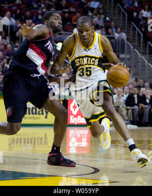 Seattle SuperSonics' Kevin Durant (R) disques durs pour le panier passé Portland Trail Blazers' Martell Webster au cours de la deuxième moitié de la Key Arena de Seattle le 24 mars 2008. Durant toutes les led buteurs avec 23 points dans les SuperSonics 97-84 victoire contre les Trail Blazers. (Photo d'UPI/Jim Bryant) Banque D'Images