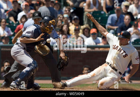 San Francisco Giants Nate Schierholtz fielder droite glisse en toute sécurité dans la maison en tant que Nouvelle York Yankee catcher Wil Nieves prend l'engagement au cours de la quatrième manche à AT&T Park à San Francisco le 24 juin 2007. (Photo d'UPI/Aaron Kehoe) Banque D'Images