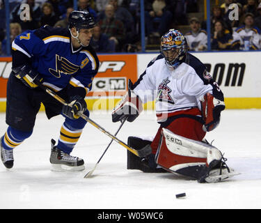 Saint Louis Blues Keith Tkachuk (L) tente de contrôler la rondelle comme gardien des Blue Jackets de Columbus Marc Denis fait une save dans periodat Savvvis la première le Centre à St Louis le 15 janvier 2004. (Photo d'UPI/Bill Greenblatt) Banque D'Images