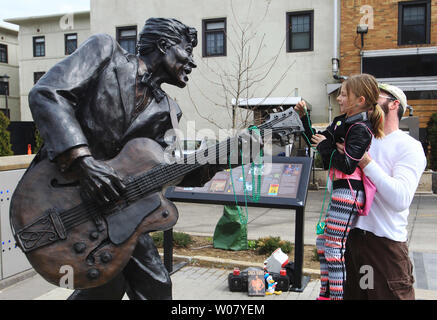 Phillip débarquer ascenseurs sa fille Zoe (7) afin qu'elle peut placer des perles sur la guitare de légende du rock and roll Chuck Berry's statue dans la boucle dans la ville universitaire, Missouri, le 19 mars 2017. Berry est décédé à son domicile à St Charles County Texas le 18 mars 2017 à l'âge de 90 ans. Photo de Bill Greenblatt/UPI Banque D'Images