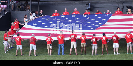 Attente des fans et agiter un drapeau américain dans centerfield pendant l'hymne national avant le Rays-St de Tampa Bay. Louis Cardinals match de baseball à Busch Stadium à St Louis le 25 août 2017. Photo de Bill Greenblatt/UPI Banque D'Images