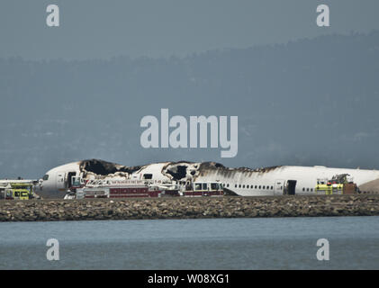 Les véhicules d'urgence entourent les vestiges d'un Boeing 777 d'Air Asiana sur la piste de l'Aéroport International de San Francisco après qu'il s'est écrasé à l'atterrissage à San Francisco le 6 juillet 2013. L'avion était en provenance de Séoul. UPI/Terry Schmitt Banque D'Images