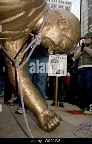 Les manifestants contre le président américain George Bush de la toute première visite au Canada de tirer vers le bas une statue de lui devant le consulat américain dans le centre-ville de Vancouver, le 30 novembre 2004. C'est l'un des dizaines de protestations à travers le Canada comme le président George Bush rencontre le Premier ministre du Canada Paul Martin à Ottawa sur la première d'une visite de deux jours. (UPI Photo/ Heinz Ruckemann) Banque D'Images