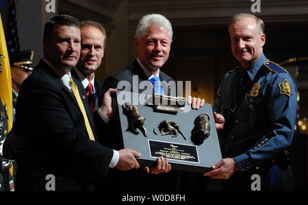 L'ancien Président Bill Clinton reçoit le 'Distinguished Service Award' de Craig W. Floyd, président et chef de la direction de l'application de la Loi nationale Officers Memorial Fund à Washington le 18 octobre 2006. L'aide à l'attribution sont le Colonel Steve Dozier, directeur, de l'Arkansas State Police (L) et le Service secret des États-Unis adjoint, agent spécial responsable Jeff Irvine (R). (Photo d'UPI/Roger L. Wollenberg) Banque D'Images
