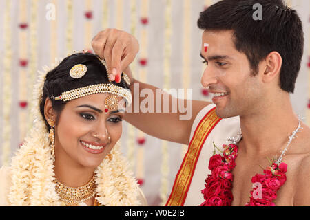 Couple performing Sindoor Daan ceremony in malayalee wedding Stock Photo