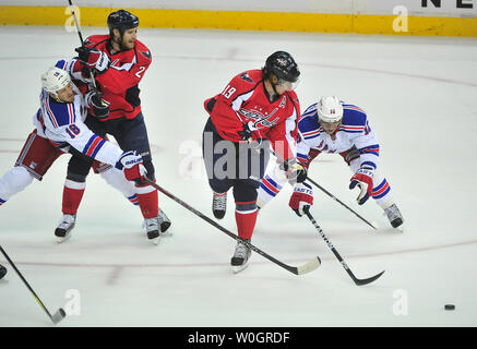 Les Capitals de Washington' Nicklas Backstrom (19) a la rondelle a été dérobé chez lui par les Rangers de New York Marian Gaborik (10) comme Capitales Brooks Laich (21) Rangers Marc Staal lutte pour la position au cours de la première période de jeu 2 de la demi-finale de conférence de l'Est de la LNH au Verizon Center à Washington, D.C., le 2 mai 2012. UPI/Kevin Dietsch Banque D'Images