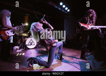 Chanteur Shannon ceintures Conley un Led Zeppelin musique assistée par Megan Thomas (L), guitariste et batteur Steph Paynes Leesa Harrington-Squyres pendant une performance de l'ensemble-girl Lez Zeppelin bande à l'Autel Bar, un converti église, à Pittsburgh, Pennsylvanie le 10 novembre 2012. Led Zeppelin le film "Jour de fête" est sorti le Blu-ray et d'autres accueil formats le 19 novembre 2012, alors que leur vie sur la musique live avec des groupes populaires comme Lez Zeppelin dans bars et théâtres à travers l'Amérique. UPI/Pat Benic Banque D'Images