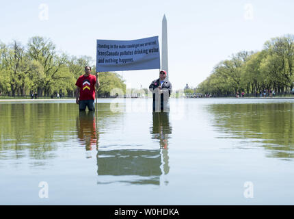 Wizipan peu l'Élan (L) et l'Art Tanderup, membres de l'Alliance indienne Cowboy et participer à une une protestation contre le pipeline KXL au miroir d'eau sur les ressortissants Mall à Washington, D.C. le 24 avril 2014. Le cow-boy et indien Alliance a organisé le pipeline de sables bitumineux Keystone XL protestation à montrer la nécessité de mettre en évidence les impacts environnementaux possibles du projet. UPI/Kevin Dietsch Banque D'Images