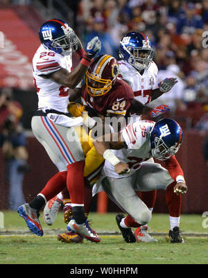 Redskins de Washington à la main l'extrémité Niles Paul (84) est touché par les Giants de New York strong safety Antrel Rolle (26), le secondeur Jacquian Williams (57) andNew la sécurité de New York Giants Quintin Demps (35) au deuxième trimestre à FedEx Field à Washington, D.C. le 25 septembre 2014. UPI/Kevin Dietsch Banque D'Images
