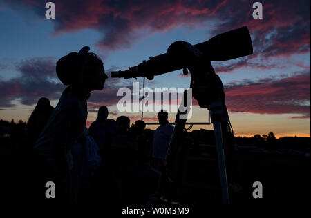 Ella pairs au moyen d'un télescope à la fête des étoiles, tenue à Madras High School la nuit avant les foules viennent à regarder l'éclipse solaire totale de Madras, Oregon le 20 août 2017. L'éclipse sera balayé une partie étroite de l'contigus des États-Unis de Lincoln Beach, Oregon à Charleston, Caroline du Sud le 21 août. Une éclipse solaire partielle sera visible à travers tout le continent nord-américain ainsi que des parties de l'Amérique du Sud, Afrique, et Europe. Photo de la NASA par Aubrey Gemignani/UPI Banque D'Images