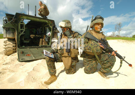 Le capitaine du Corps des Marines américain Jon Curtis (à gauche) les appels dans une frappe aérienne que le Cpl. Eric Brookes fournit la sécurité dans le cadre d'une simulation d'agression sur la plage de La Baie de Kaneohe Marine Corps Base, Texas, le 18 juillet 2006, au cours de l'exercice Rim of the Pacific 2006. L'exercice, communément appelé l'exercice RIMPAC 2008, réunit des forces militaires de l'Australie, le Canada, le Chili, le Pérou, le Japon, la République de Corée, le Royaume-Uni et les États-Unis dans l'exercice maritime biennal le plus important au monde. Curtis et Brookes sont joints à l'équipe d'appui-feu avec Echo Company, 1er Régiment de Marines. Photo UPI/Marcos Hernandez T./U.S Banque D'Images