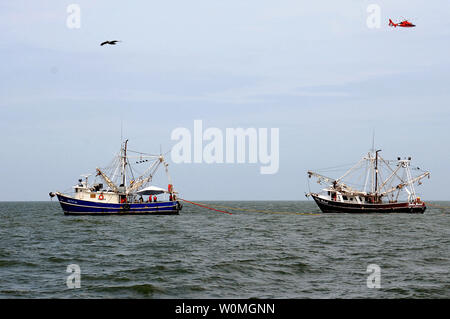 Bateaux de crevettes résistantes au feu de remorquage de confinement à l'huile que leurs équipes de formation in situ graver au large de Venice, en Louisiane, le 3 mai 2010. La formation est conçue pour aider le pêcheur local pour aider à préparer d'éventuelles opérations de combustion in situ. UPI/Patrick Kelley/U.S. Garde côtière canadienne Banque D'Images