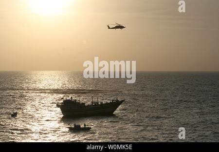 Un U.S. Navy SH-60S Sea Hawk offre un soutien à une équipe de lutte contre la piraterie attribué à missiles de l'USS Kidd comme ils sauvetage 13 Iraniens et de détenir 15 pirates présumés à bord du boutre de pêche battant pavillon iranien Al Mol dans la mer d'Oman Le jeudi 5 janvier 2012. Kidd mène la lutte contre la piraterie et les opérations de sécurité maritime pendant le déploiement de la 5e Flotte des États-Unis zone de responsabilité. UPI/U.S. Navy Banque D'Images