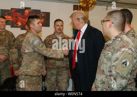 Le président américain, Donald J. Trump parle aux militaires déployés à l'appui de la Force opérationnelle interarmées - Fonctionnement résoudre inhérents (GFIM-OIR) au cours de sa visite des troupes d'Al Asad Air Base, l'Iraq, le 26 décembre 2018. Les GFIM-OIR fonctionne par, avec, et par les forces des partenaires pour vaincre ISIS. Photo de 1er lieutenant Leland White/U.S. Army National Guard/UPI Banque D'Images