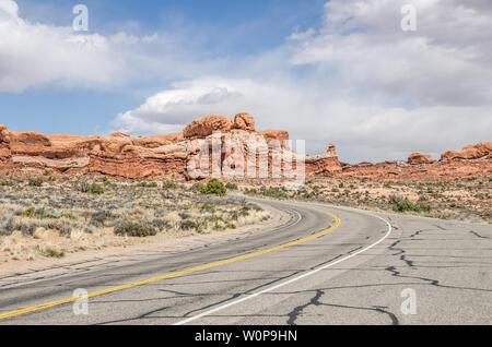 Courbe en S vous entraîne dans plus de beaux paysages sur ce park road à Arches National Park Banque D'Images