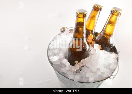 Bouteille de bière en métal seau plein de glaçons sur tableau blanc. Composition horizontale. Vue d'en haut. Banque D'Images