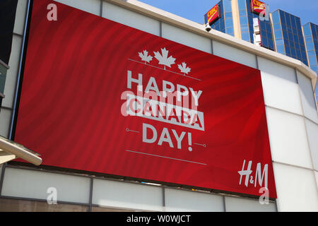 Une 'Bonne fête du Canada' affichage LED visibles à l'extérieur le magasin H & M que la ville se prépare à célébrer la fête du Canada 152th à Toronto. Banque D'Images