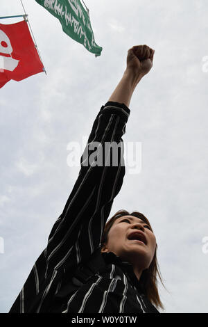 Tokyo, Japon. 28 Juin, 2019. Une dame race son poing au cours d'une manifestation près de la Port d'Osaka Dimond Point.Le même jour et de haute sécurité de la police pourrait être vu à Osaka au Japon au cours de la visite des présidents, premiers ministres et autres hauts dirigeants du monde entier, qui se sont réunis pour le sommet annuel du Groupe des 20 le 28 juin 2019. Photo par : Ramiro Agustin Vargas Tabares Crédit : Ramiro Agustin Vargas Tabares/ZUMA/Alamy Fil Live News Banque D'Images