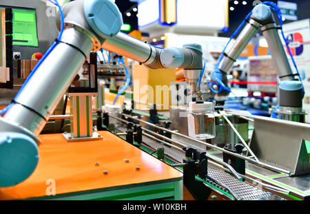Le bras robot de verre disposés sur la bouteille d'eau dans l'équipement automatique de machines industrielles factory de la ligne de production Banque D'Images