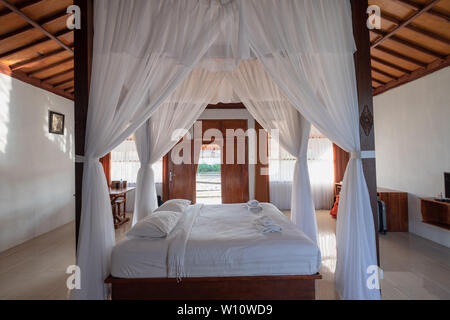 L'Est de Java, Indonésie - 10 Sep 2018 : chambre à coucher en bois l'architecture de style balinais avec rideau de tropical villa de luxe Banque D'Images