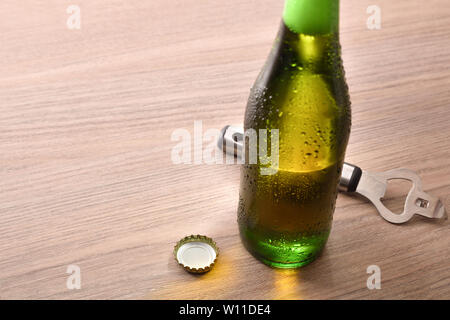 Bouteille verte avec boisson alcoolisée à la table en bois élevé. Composition horizontale. Vue élevée. Banque D'Images
