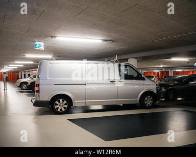 Haarlem, Pays-Bas - Aug 19, 2018 : Néerlandais parking souterrain avec silhouette de femme en arrière-plan et nouvelle Volkswagen Transporter wan d'argent Banque D'Images