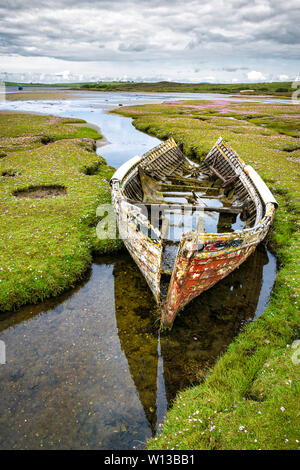 Une vieille épave brisée d'un bateau de pêche à gauche sur l'entrée du marais à la mer. Cela a été pris dans le comté de Mayo en Irlande. Banque D'Images