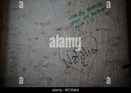 Cologne, Allemagne. 19 Juin, 2019. Messages écrits avec feutre par les visiteurs peut être vu dans l'escalier de la tour sud de la cathédrale. Vols, vandalisme, graffiti - cela peut également affecter les églises. Parfois, les dommages idéal est plus élevé que le préjudice matériel. L'Allemagne est plus grande cathédrale est particulièrement touché. (Dpa 'vandalisme dans les églises - 'qui déjà fait mal dans l'âme') Credit : Henning Kaiser/dpa/Alamy Live News Banque D'Images