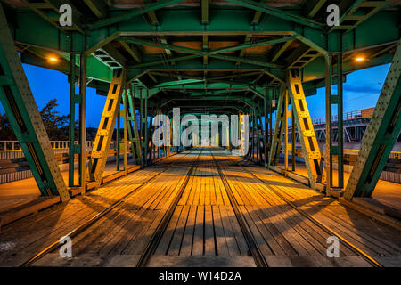 Belle de nuit Pont Gdansk à Varsovie, Pologne, treillis en acier construction avec des voies de tram, l'infrastructure de la ville, le point de fuite perspective. Banque D'Images