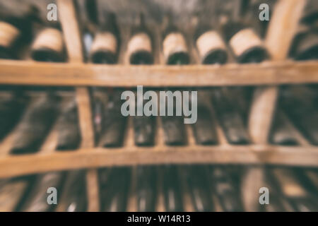 Vieilles bouteilles de vin sur les tablettes dans la cave à vin, un arrière-plan flou Banque D'Images