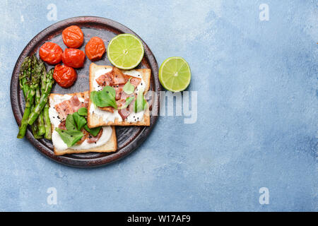 La plaque avec des toasts et des légumes savoureux sur un fond de couleur Banque D'Images