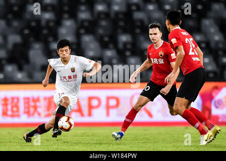 Joueur de football Selnaes Norvégien Ole, droit, de Shenzhen C.F. défis un joueur de Shanghai EPOP dans leur 15e match au cours de l'Association de football chinoise 2019 Super League (CSL) dans la ville de Shenzhen, province du Guangdong en Chine du sud, le 30 juin 2019. Epop Shanghai Shenzhen défait C.F. 1-0. Banque D'Images