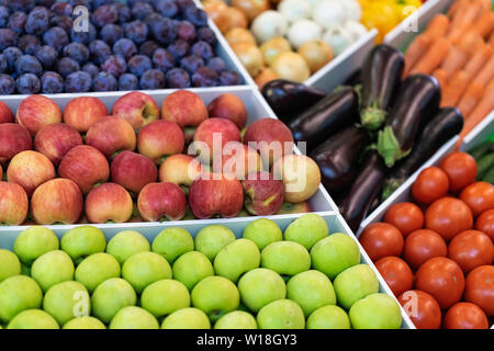 Un assortiment de fruits et légumes dans un bac sur le marché Banque D'Images