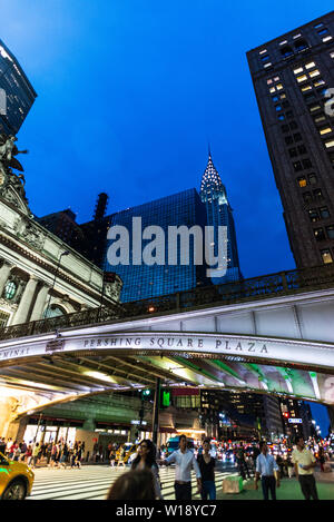 La ville de New York, USA - 1 août 2018 : Façade du Grand Central Terminal, terminal de trains de banlieue, de nuit avec des gens autour et le Chrysler Buildi Banque D'Images