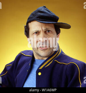 Moyen-âge homme portant une casquette de baseball à la recherche en colère et frustrés Banque D'Images