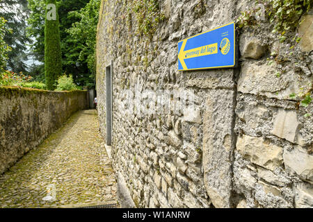 Le lac de Côme, Italie - Juin 2019 : signe montrant les marcheurs l'itinéraire sur un sentier de promenade sur le lac de Côme - la Voie verte del Lago di Como. Banque D'Images