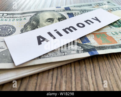 Paiements de pension alimentaire. Pile de dollars avec l'argent de la pension alimentaire et de la signer. Divorce et séparation concept. Banque D'Images