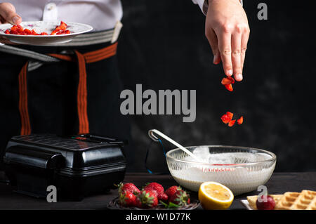 L'ajout de chef des fruits dans la pâte à gaufres close up Banque D'Images