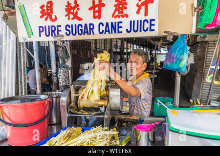 Un pur jus de canne à sucre stall à George Town, l'île de Penang, en Malaisie, en Asie du sud-est, en Asie. Banque D'Images