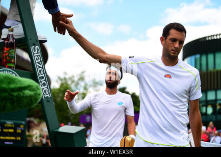 James Ward (à droite) après sa défaite à Nikoloz Basilashvili le deuxième jour des championnats de Wimbledon au All England Lawn tennis and Croquet Club, Wimbledon. Banque D'Images